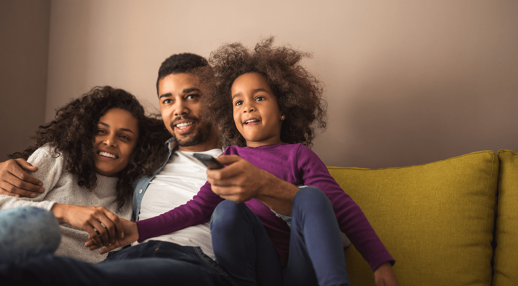 african american family watching television together