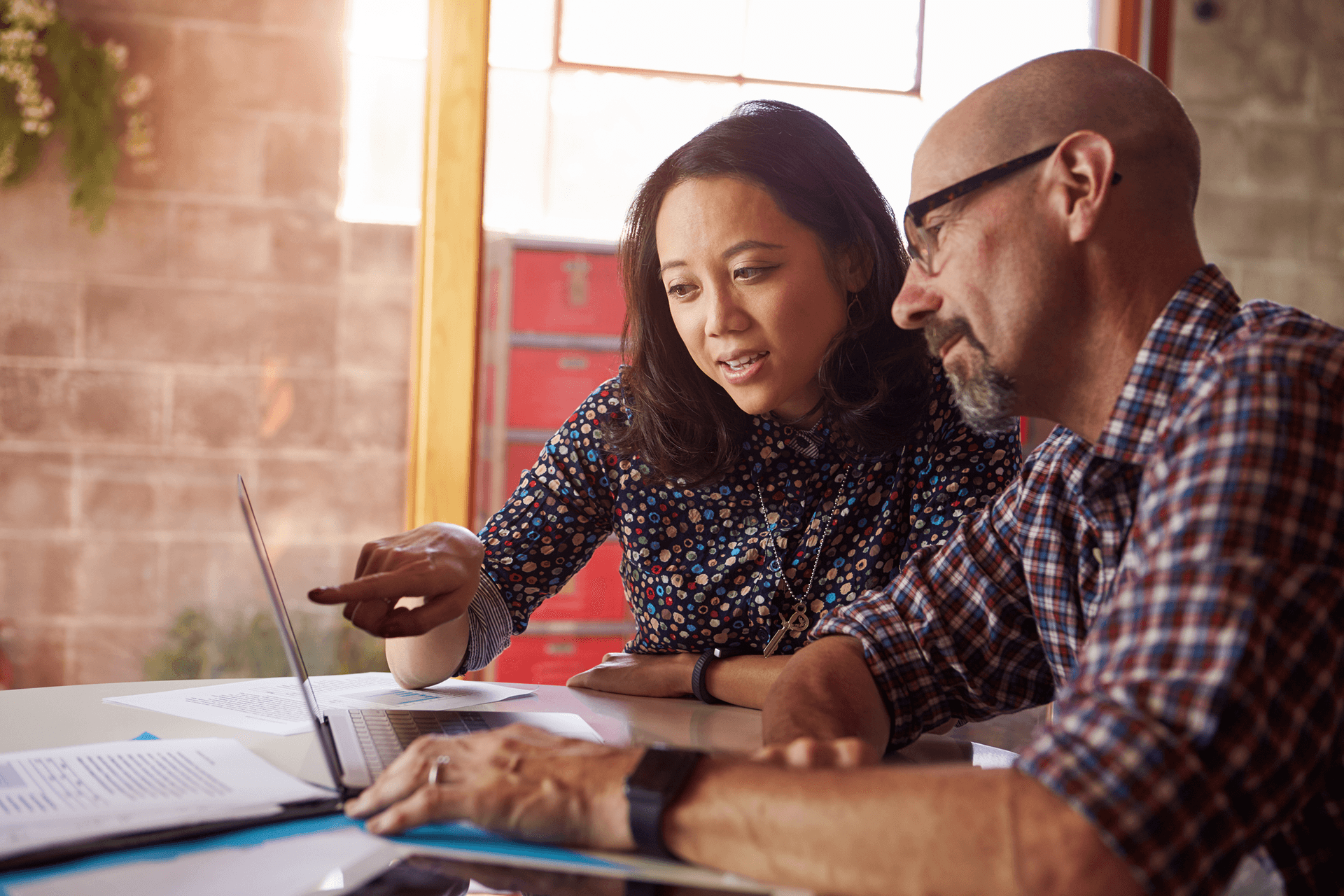 woman and man looking at laptop