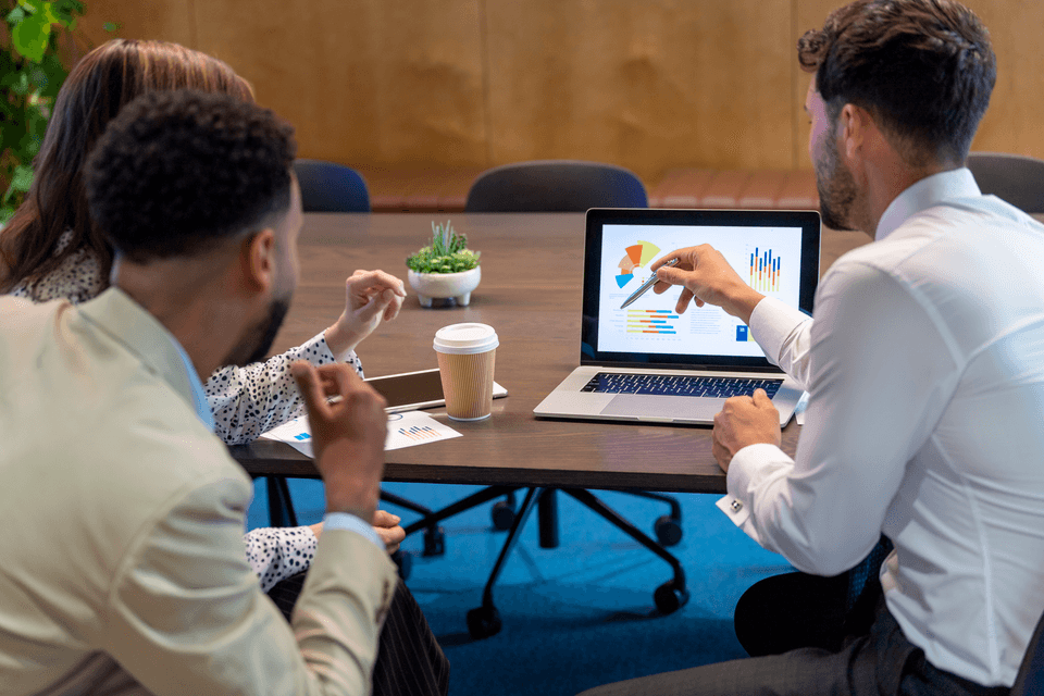 co-workers analyzing data on a laptop