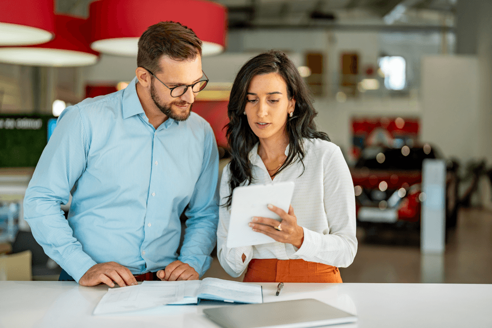 coworkers looking at a tablet screen