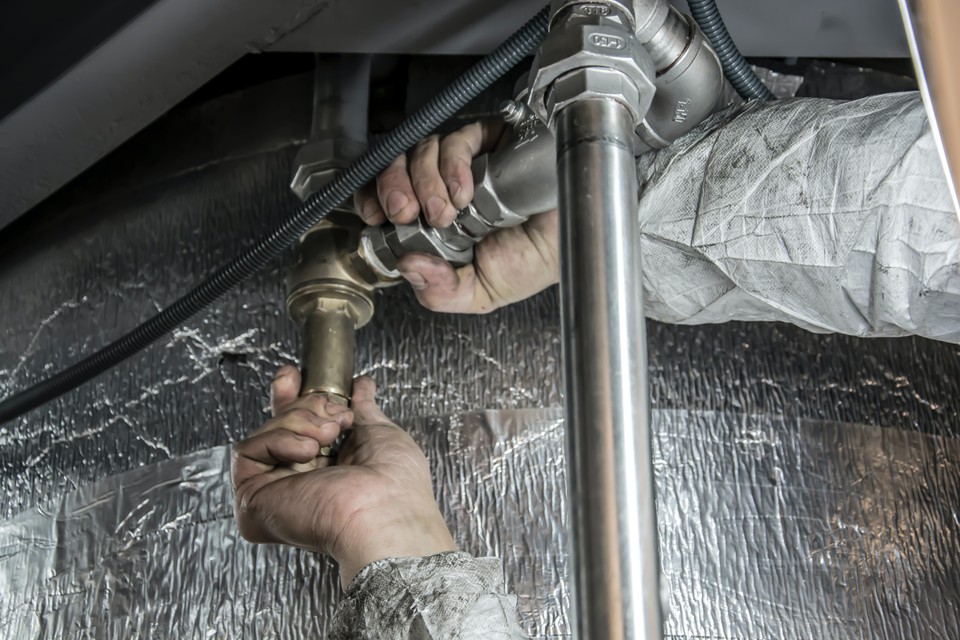 plumber working under the sink