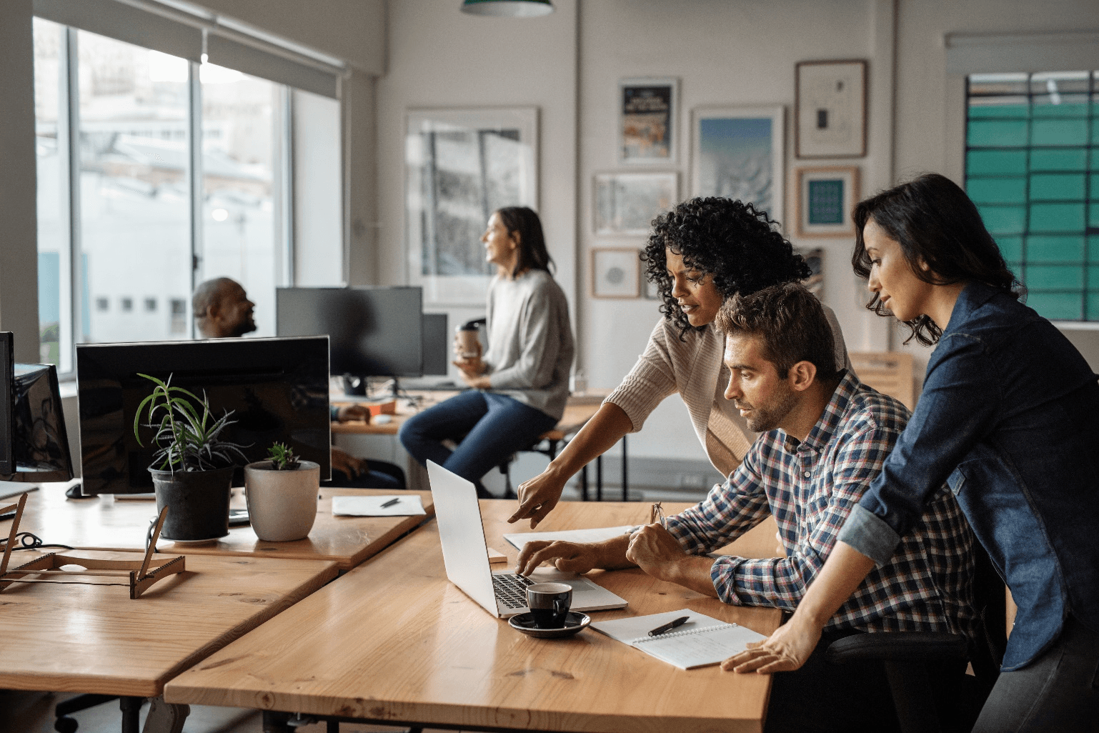 Group of workers looking at computer in an office