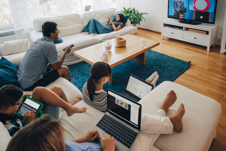 multiple people relaxing each with a different device