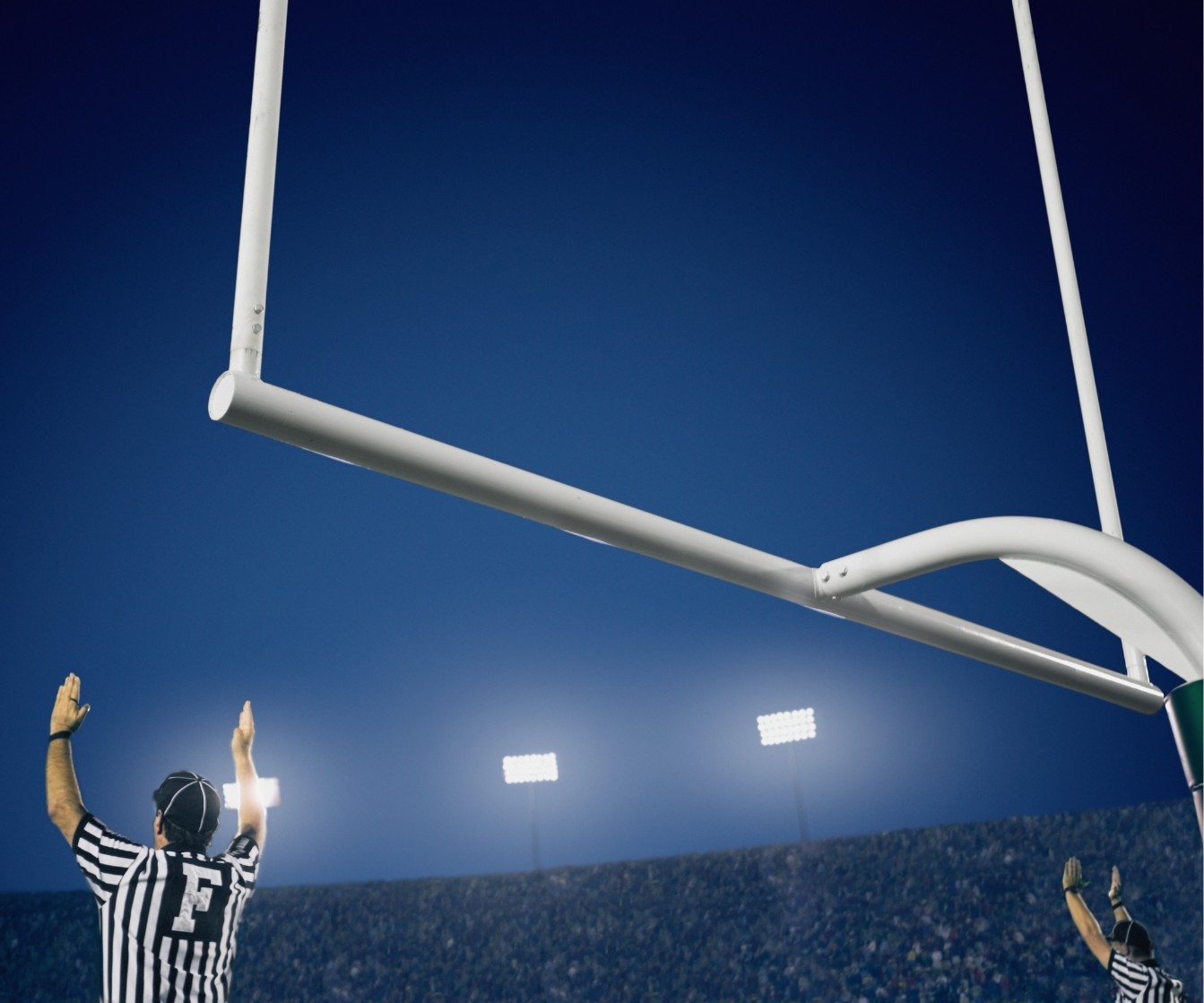 referee signals a good field goal and extra point
